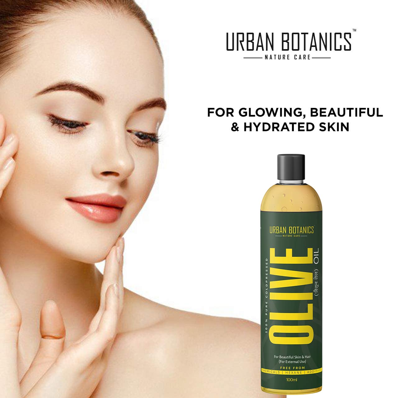 Woman touching her face with a bottle of Urban Botanics Olive Oil on a white background