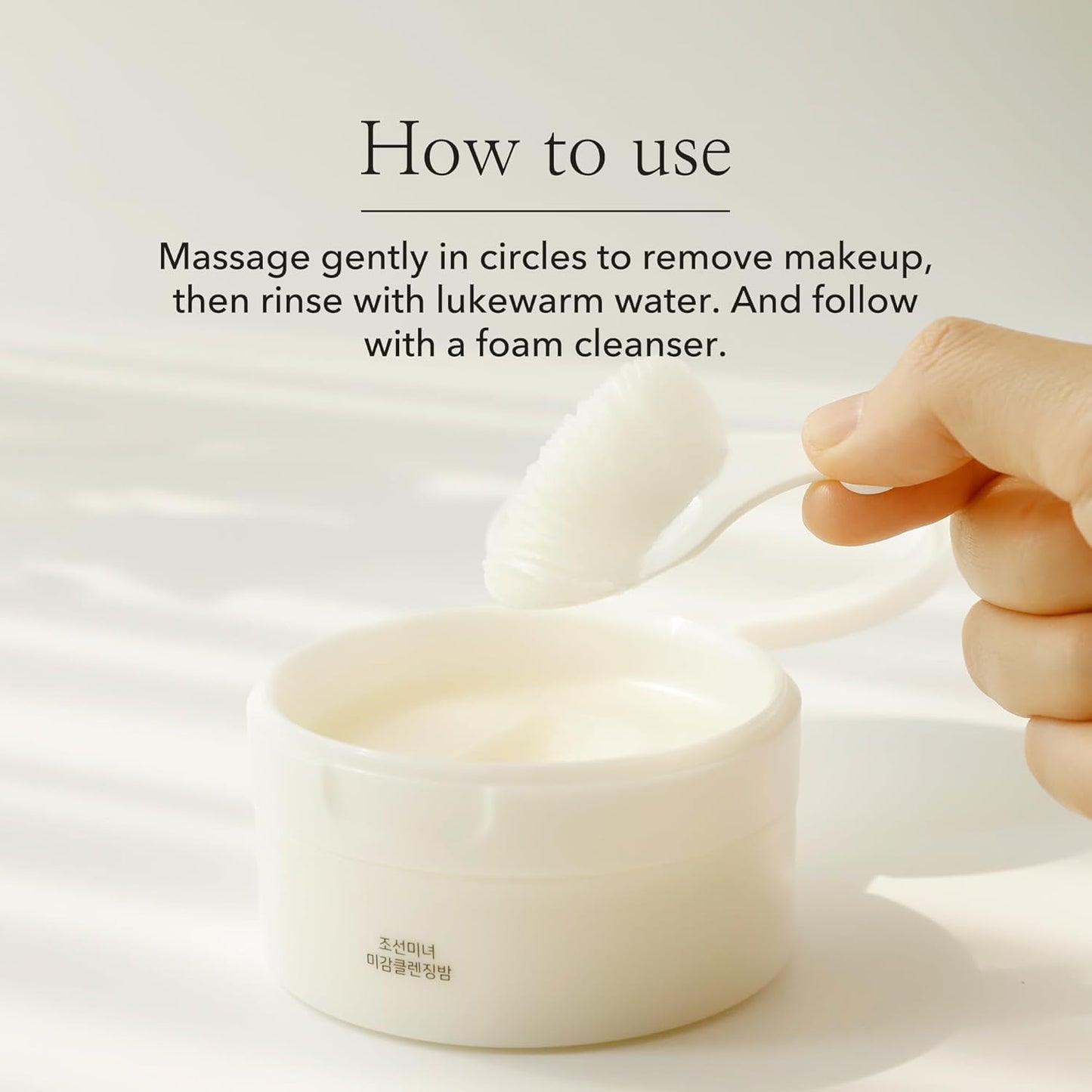 Hand using a white spoon to scoop cream from a jar with text on how to use it.