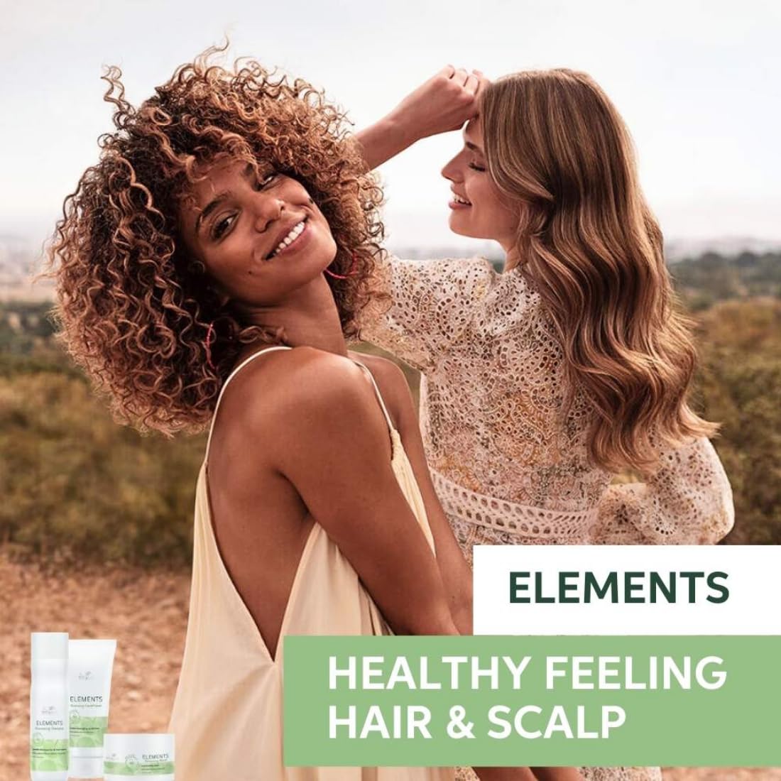 Two women outdoors with 'Elements' hair care products displayed.