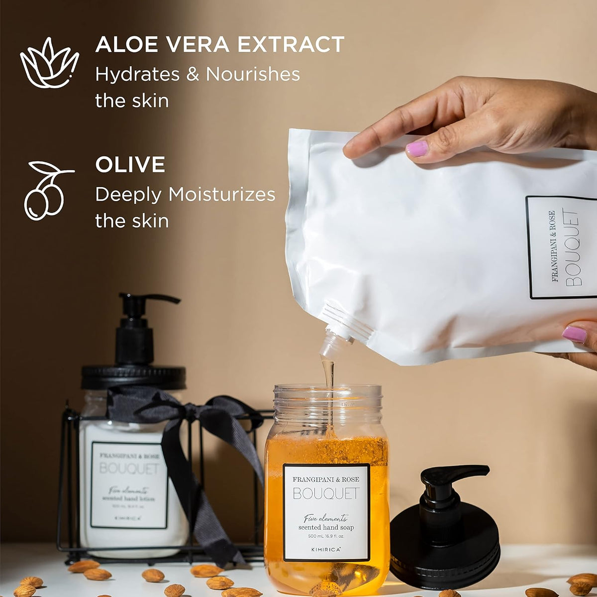 Hand pouring aloe vera extract into a jar with product packaging and ingredients on a beige background.