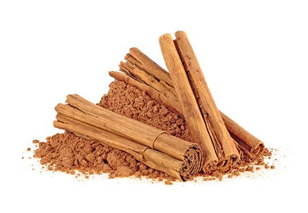 Cinnamon sticks and ground cinnamon on a white background