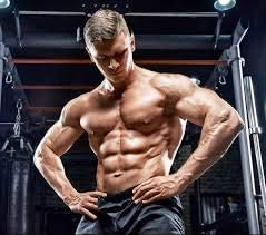 Muscular man posing in a gym setting