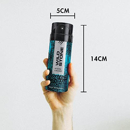 Hand holding a Wild Stone deodorant spray bottle with measurements on a white background