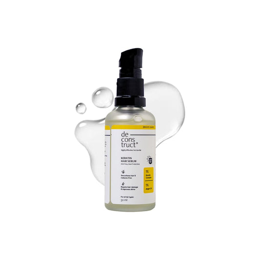 Keratin hair serum bottle with droplets on a white background