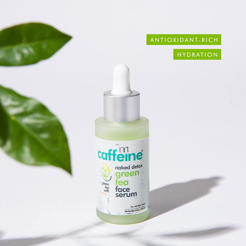 Bottle of green tea face serum with green leaves in the background
