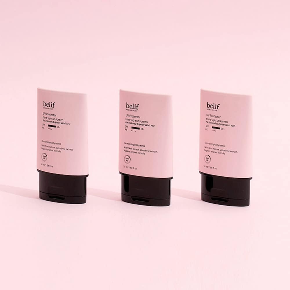 Three Belif skincare products on a pink background