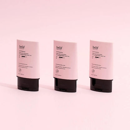 Three Belif skincare products on a pink background