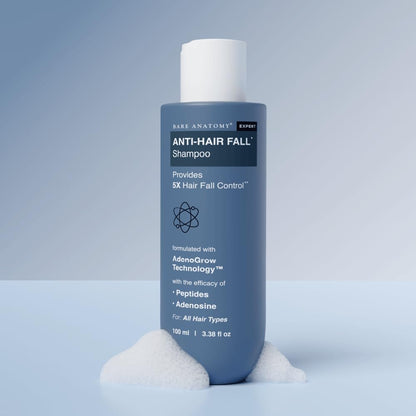 Bottle of Anti-Hair Fall Shampoo on a light blue background