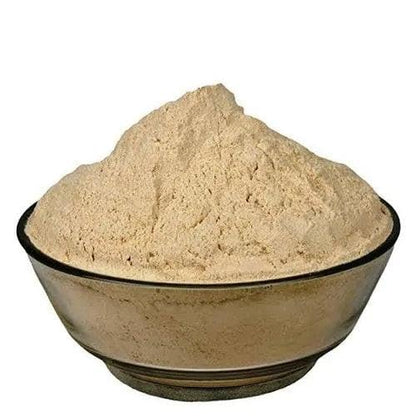 Beige powder in a black bowl on a white background