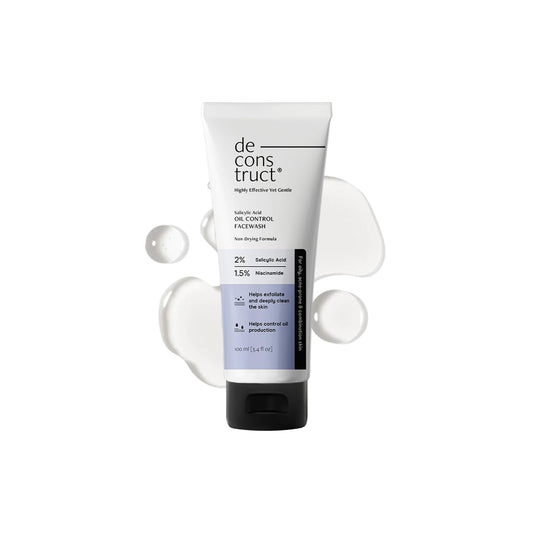 Tube of de construct facial wash with bubbles on a white background