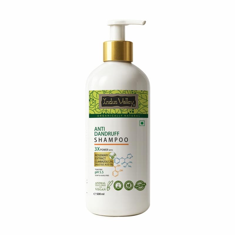Anti-dandruff shampoo bottle with a gold pump on a white background