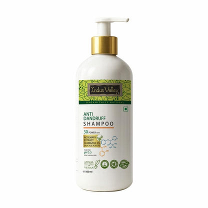 Anti-dandruff shampoo bottle with a gold pump on a white background