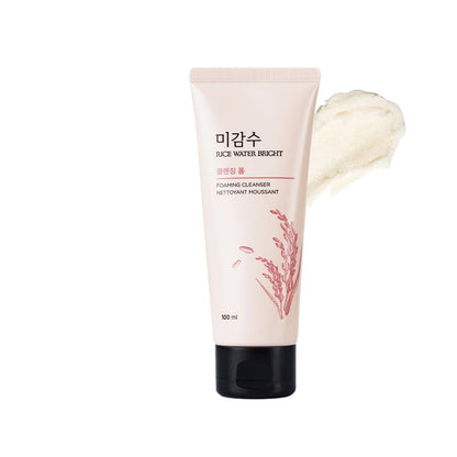 Foaming cleanser tube with a sample of cream on a white background
