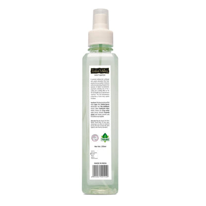 Clear spray bottle with a label on a white background