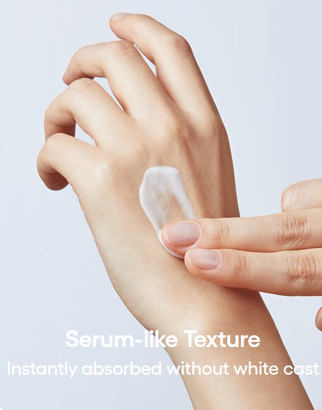 Hand applying a serum-like texture product on another hand with a light background