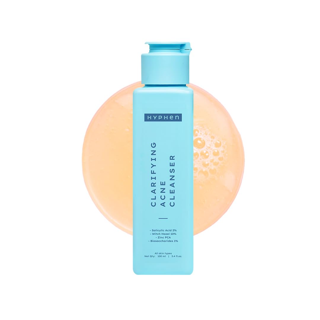 Hyphen clarifying acne cleanser bottle with a peach-colored sponge on a white background
