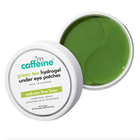 Green tea hydrogel under eye patches in a container with 'm caffeine' branding.