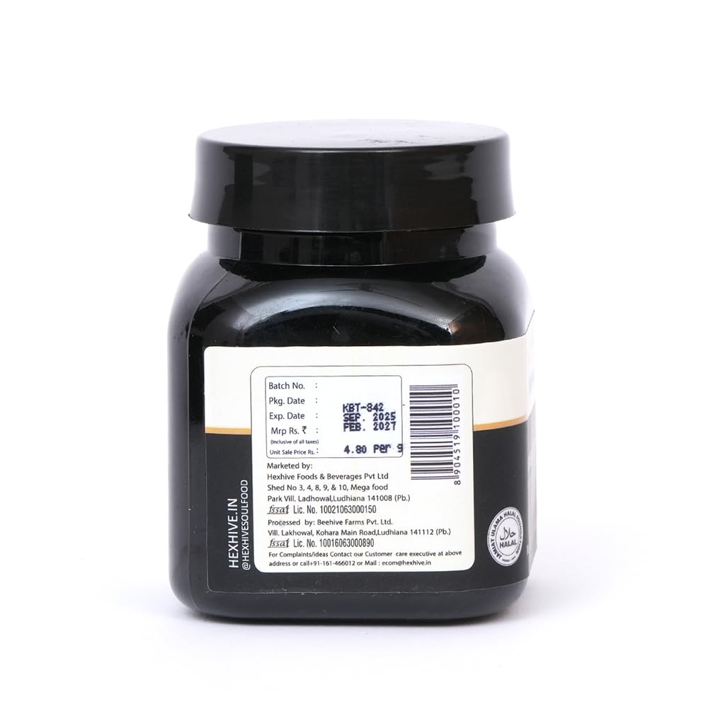 Black jar with a label on a white background