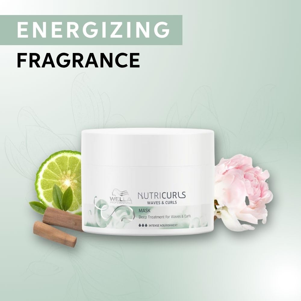 Wella Nutricurls mask with lime, cinnamon stick, and flower on a light green background
