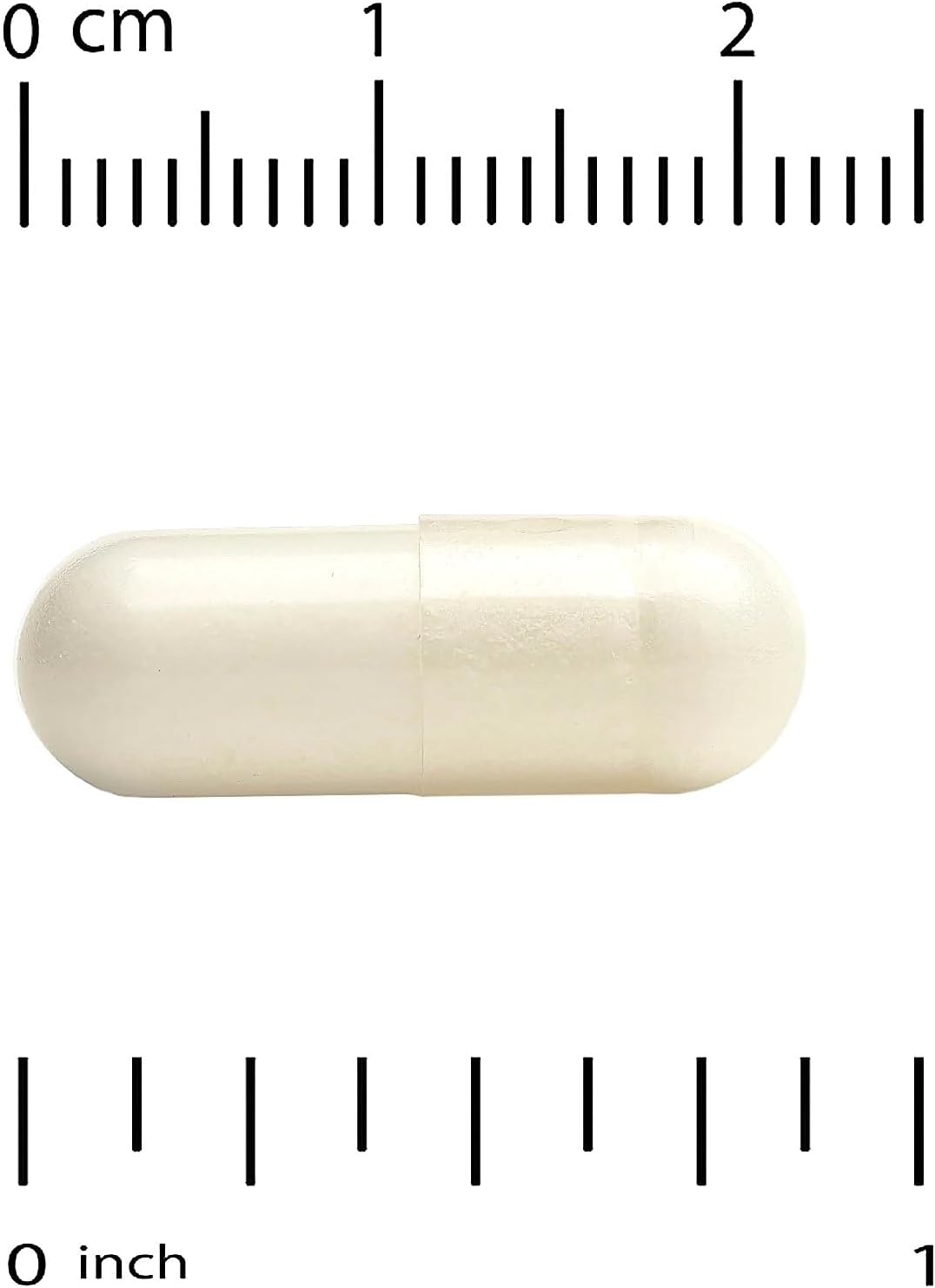 White capsule pill with a ruler for scale on a white background