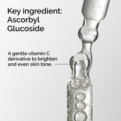 Vial of skincare product with text about ascorbyl glucoside and its benefits.