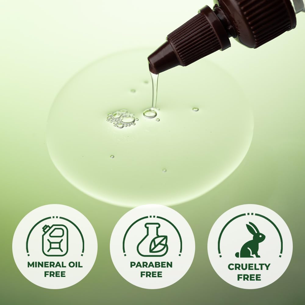 Dropper with liquid being poured onto a green background, featuring icons for mineral oil free, paraben free, and cruelty free.