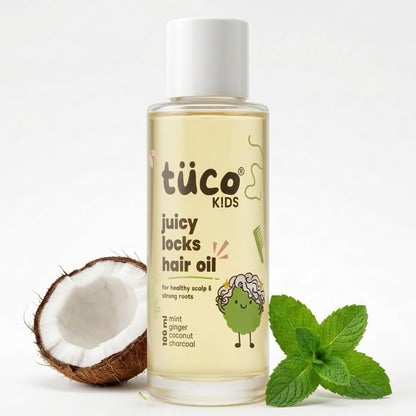 Bottle of tüco Kids juicy locks hair oil with a coconut and mint leaves on a white background
