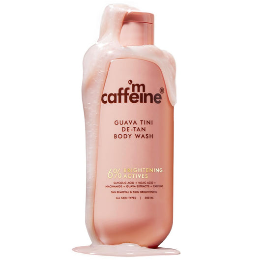 Caffeine Guava Tini De-Tan Body Wash bottle with foam on a white background