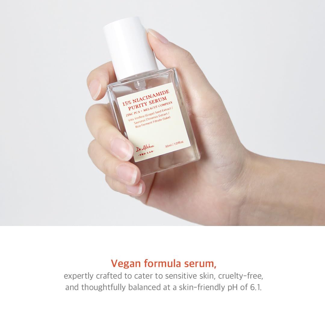 Hand holding a skincare serum bottle with product details on a white background