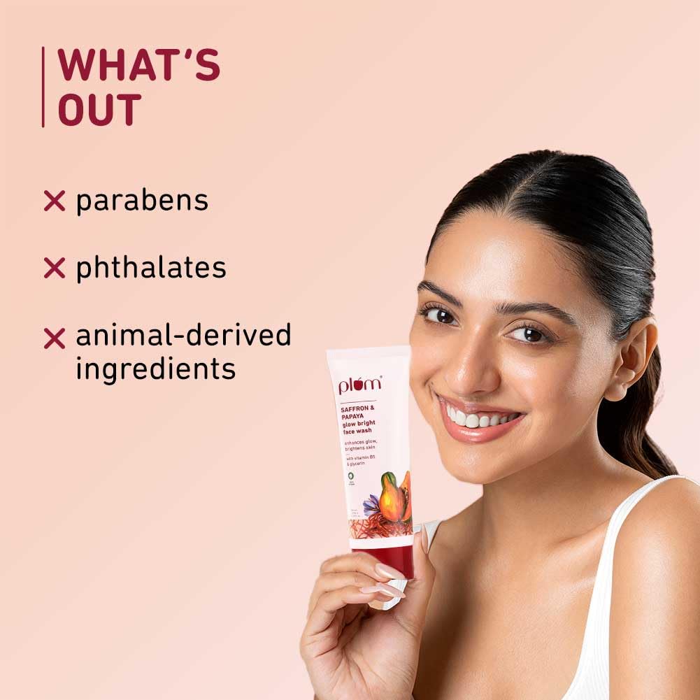 Woman holding a skincare product with 'What's Out' text on a pink background