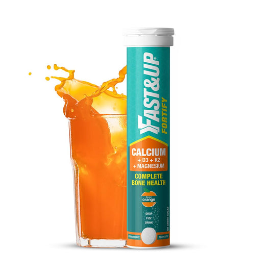 Fast&Up Fortify supplement tube with orange juice on a white background