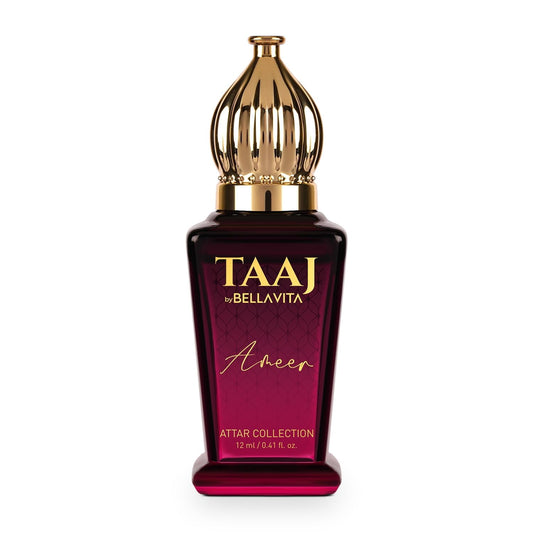 Perfume bottle with gold cap and maroon label on a white background