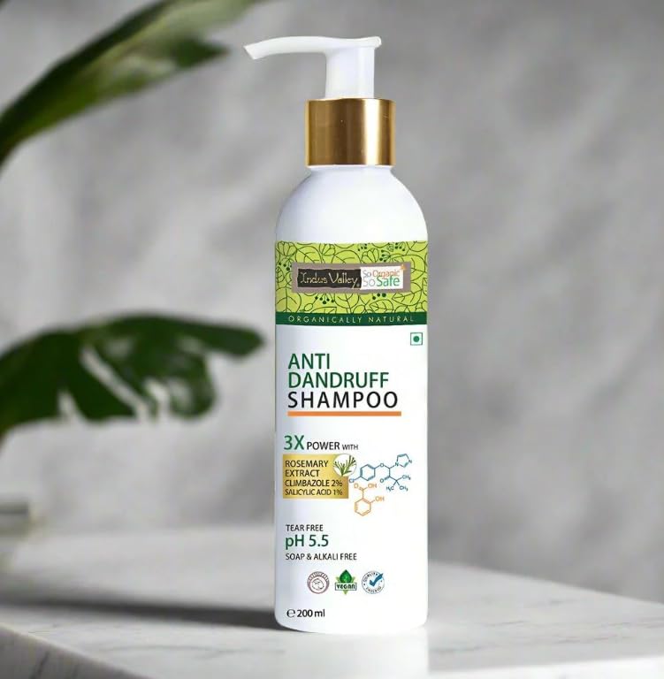Anti-dandruff shampoo bottle with green label on a neutral background