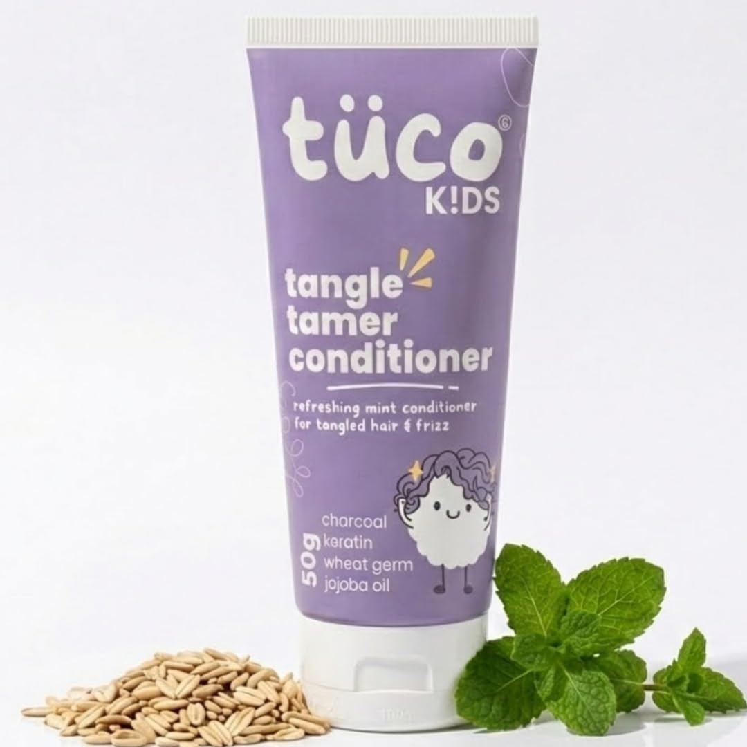 Tube of tüco Kids tangle tamer conditioner with mint leaves and nuts on a white background