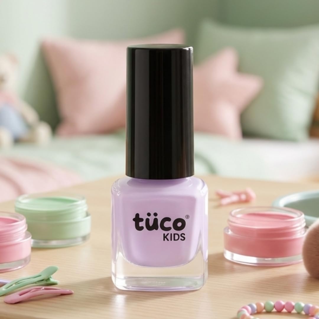 Tuóco Kids nail polish bottle on a table with a soft focus background