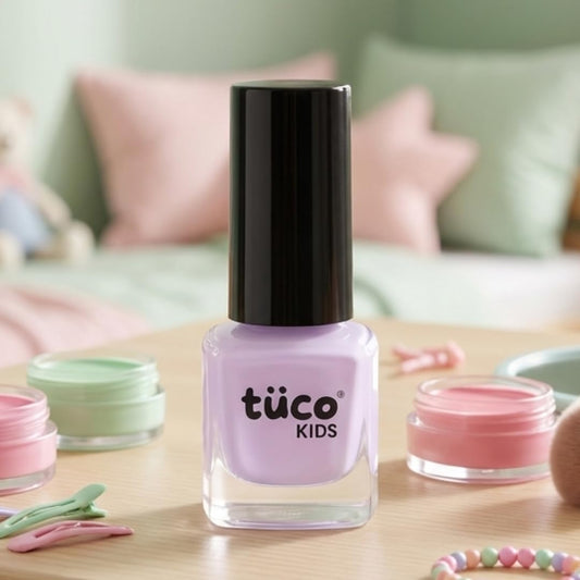 Tuóco Kids nail polish bottle on a table with a soft focus background