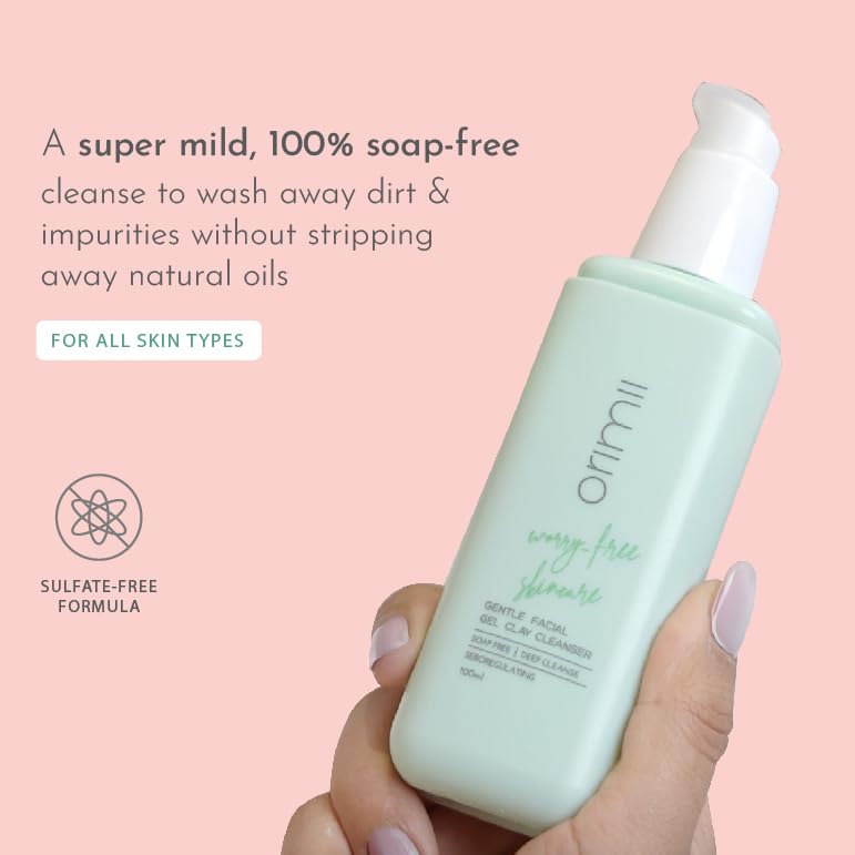 Orimi cleanser bottle held by a hand with text on a pink background
