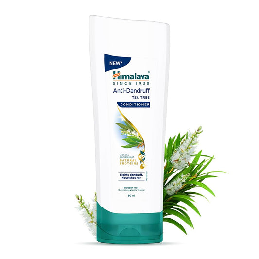 Himalaya Anti-Dandruff Tea Tree Conditioner bottle with tea tree leaves on a white background