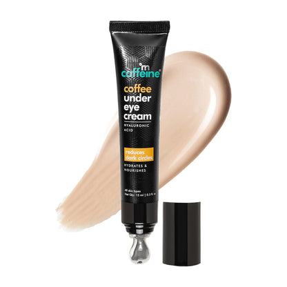 Tube of coffee under eye cream with a swatch on a white background