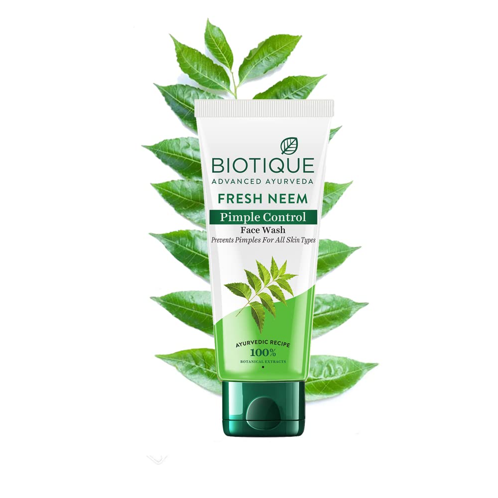 Biotique Fresh Neem Pimple Control Face Wash with green leaves on a white background