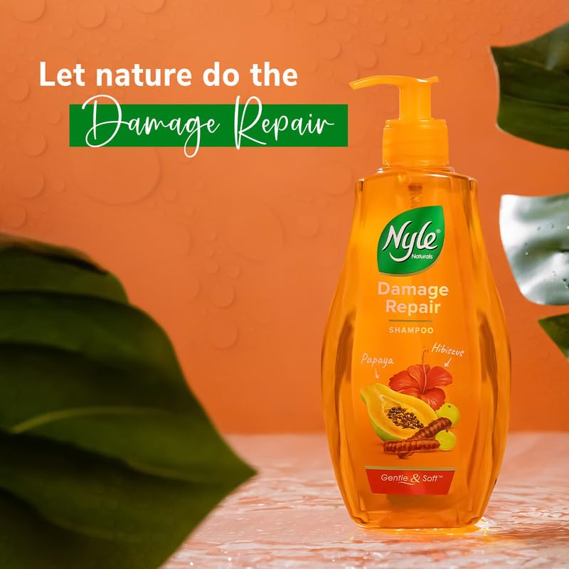 Nyle Damage Repair shampoo bottle with leaves on an orange background