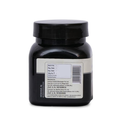 Black jar with a label on a white background