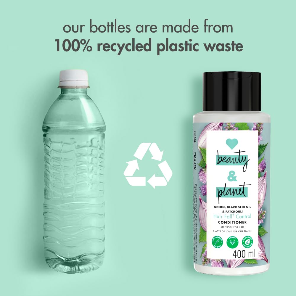 Bottle of shampoo and conditioner with a recycling symbol and text about recycled plastic bottles on a light green background.