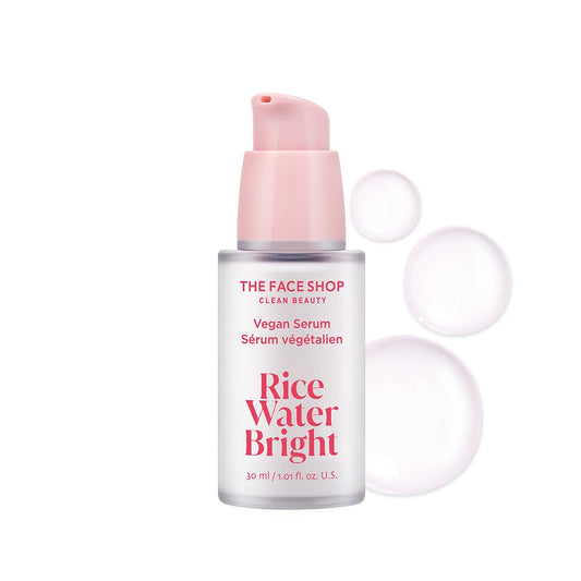 The Face Shop Rice Water Bright serum bottle with pink cap on a white background