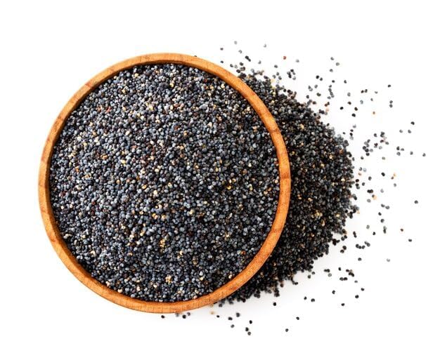 Wooden bowl filled with black chia seeds on a white background