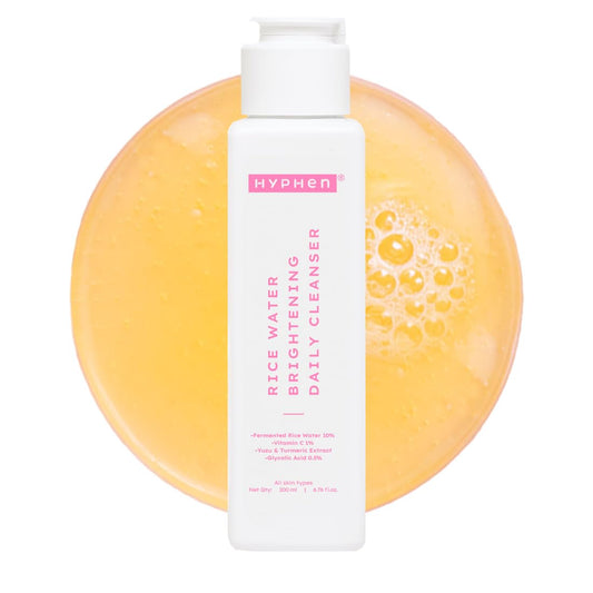 Hyphen rice water cleanser bottle with a yellow soap bar on a white background