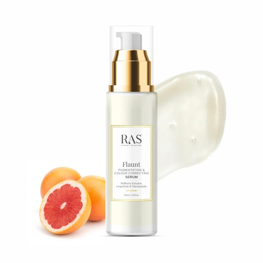 Skincare serum bottle with gold cap and 'RAS' branding, surrounded by grapefruit slices on a white background.