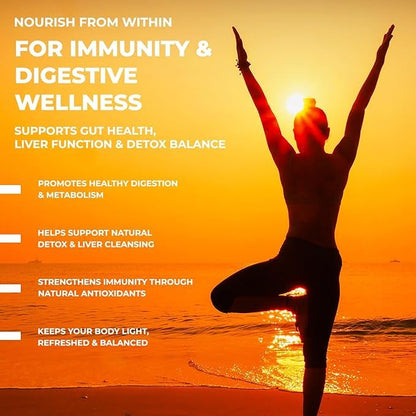 Person in a yoga pose on a beach with a sunset, promoting immunity and digestive wellness.