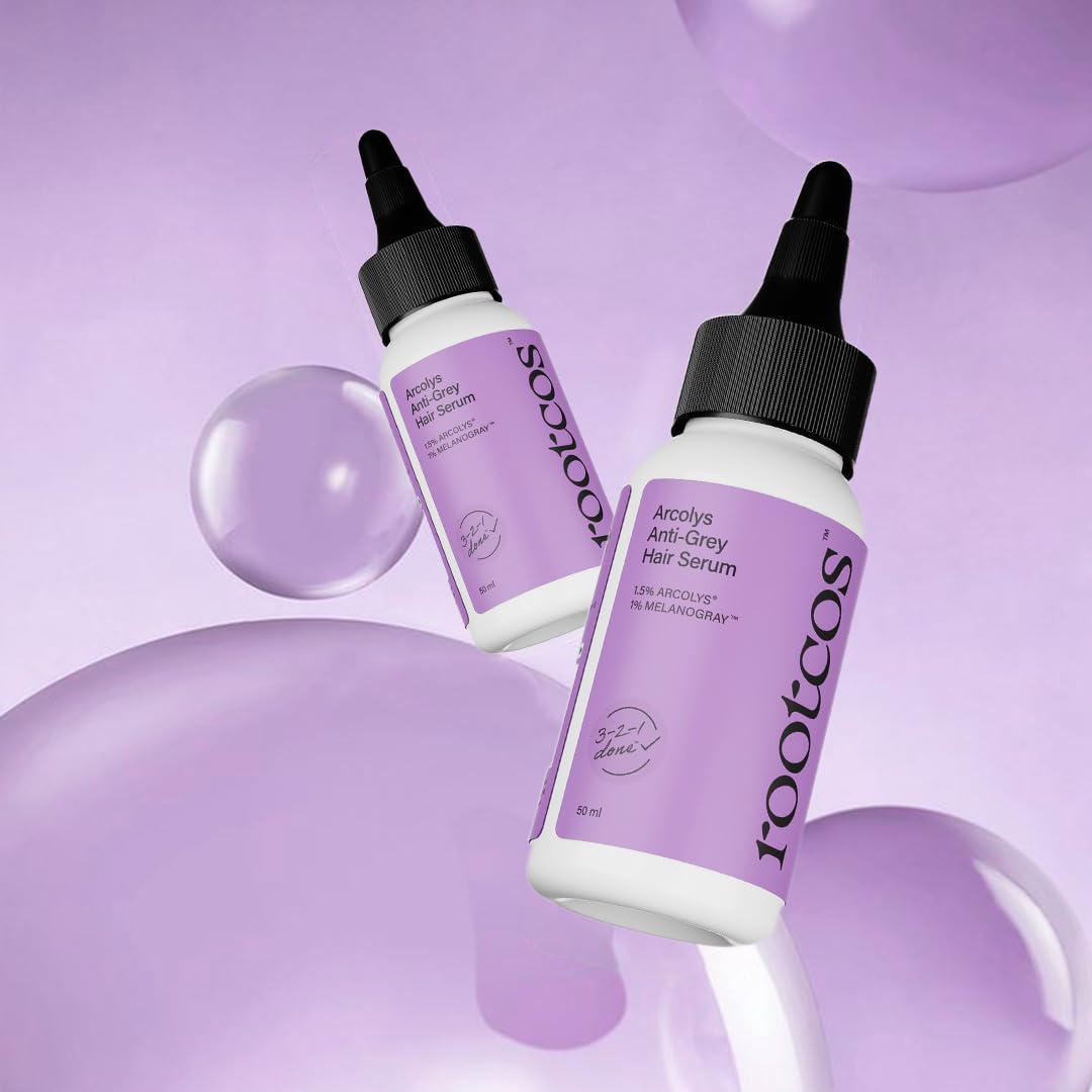 Two bottles of rootcos Acetyle Anti-Grey Hair Serum on a purple background with bubbles.