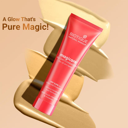 Red Biotique foundation tube with gold decorative elements on a beige background